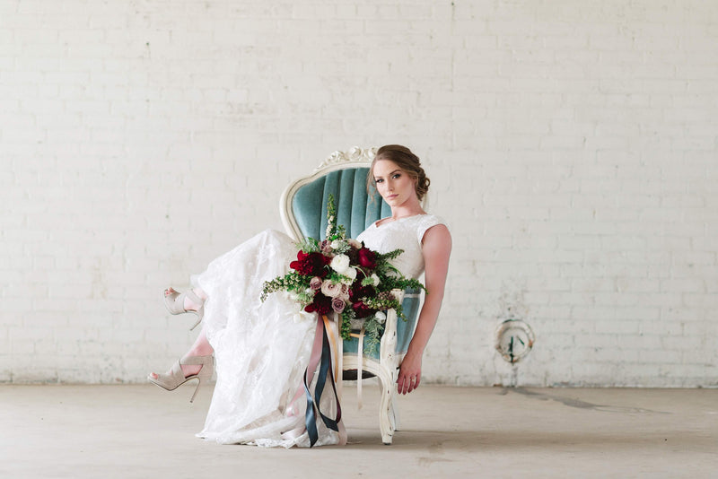 Bride sitting on blue velvet chair