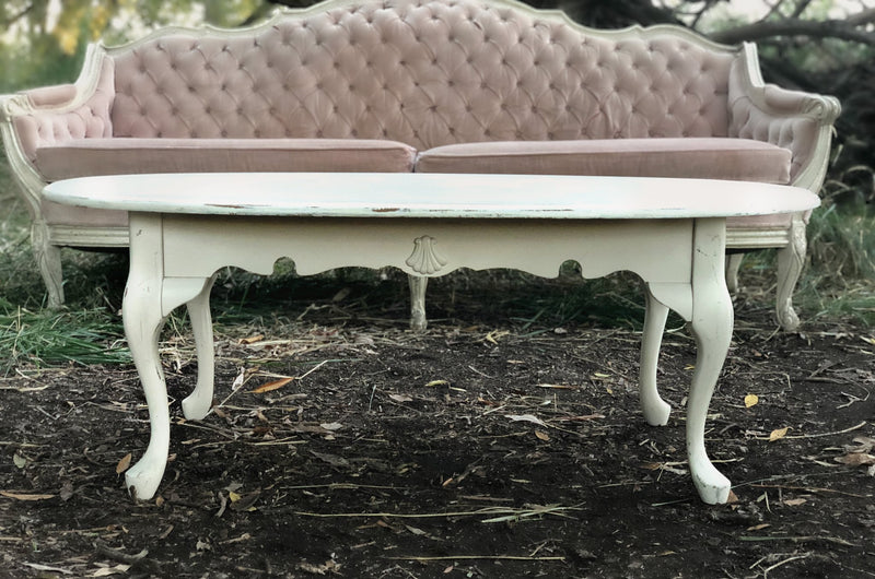 Cream coffee table with pink sofa