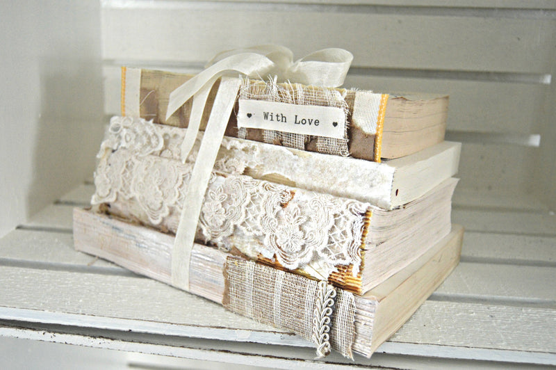 Cream vintage books bundled together for wedding centerpieces