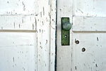 Antique doors with green doorknob