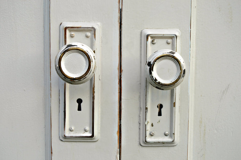 Antique white doors and doorknobs