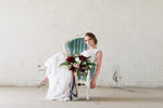 Bride sitting on blue velvet chair