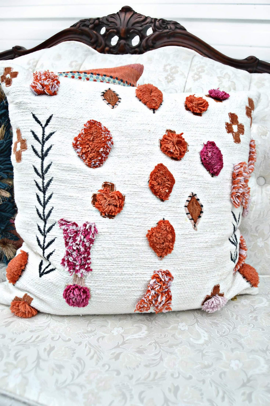 Bohemian throw pillow with pink and orange poms