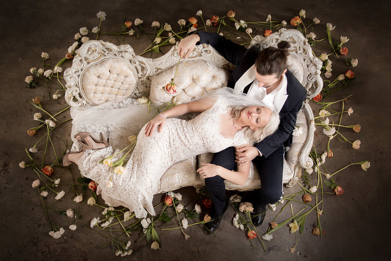 Bride and Groom lounging on beautiful Victorian settee