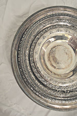 Ornate vintage silver dishes stacked