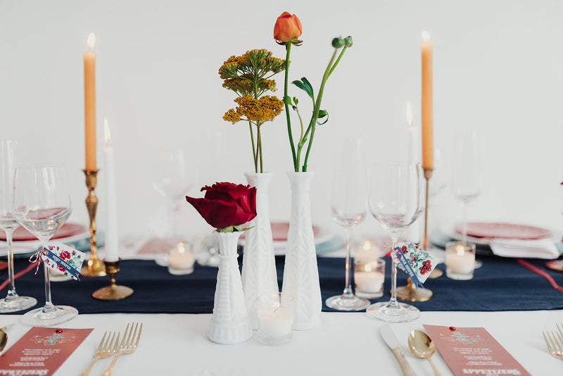 Milk glass vases with bright florals as centerpieces